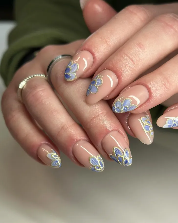 Dark blue turquoise French tip floral nails - sophisticated hand showcasing dark blue base with turquoise French tips, featuring colorful flower petals and green leaves on almond-shaped nails